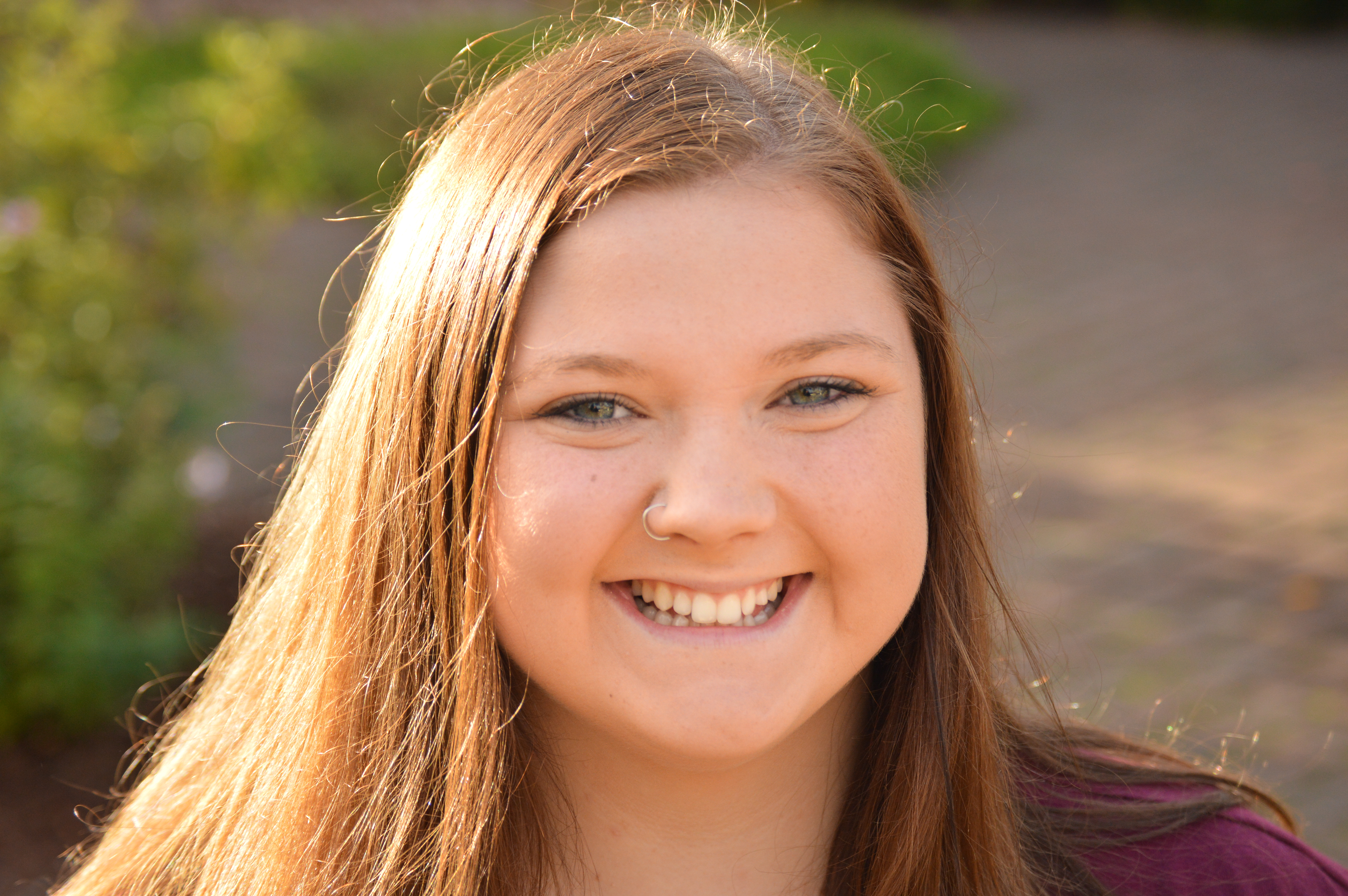 very young girl around 13 smiling in the sunlight